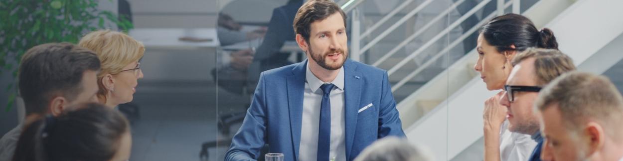 Business man giving a lecture to a group of listeners